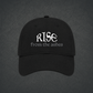 A black dad hat with embroidered text reading 'RISE from the ashes' on the front.