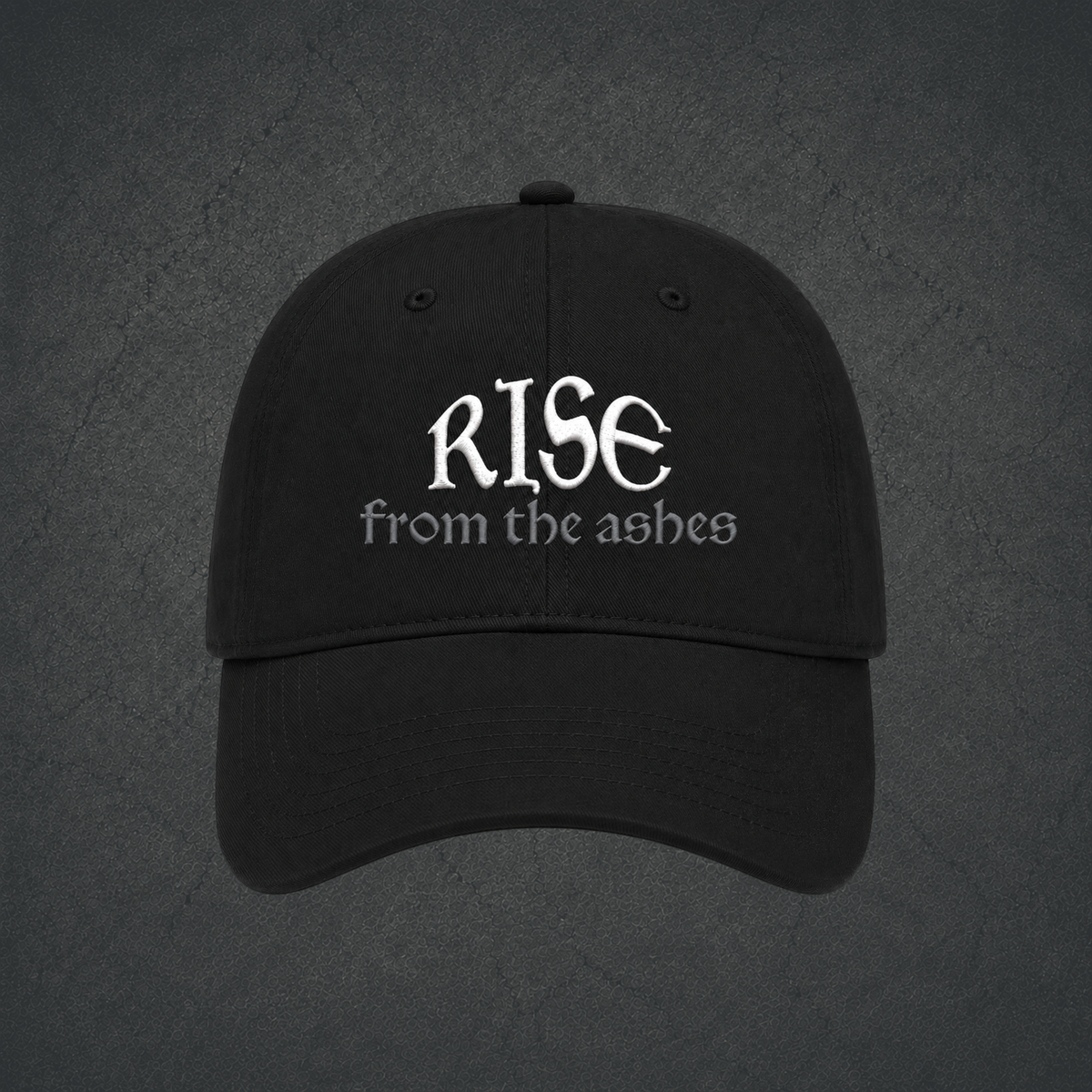 A black dad hat with embroidered text reading 'RISE from the ashes' on the front.