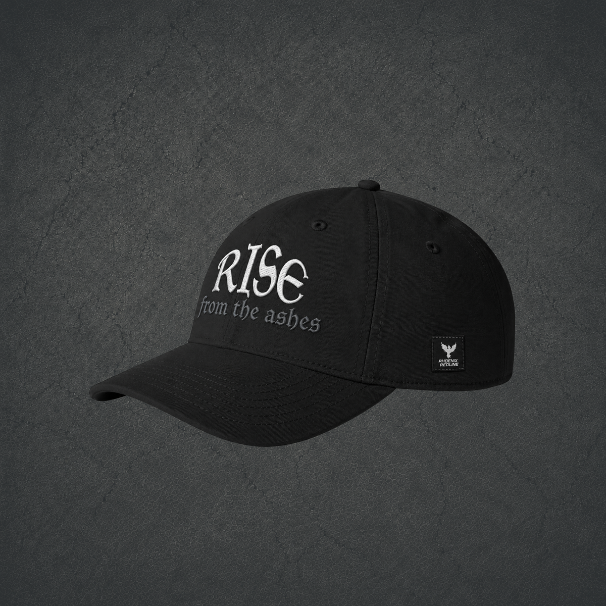 Side view of black dad hat with "Rise from the ashes" embroidered on the front and a Phoenix Redline label on the side.